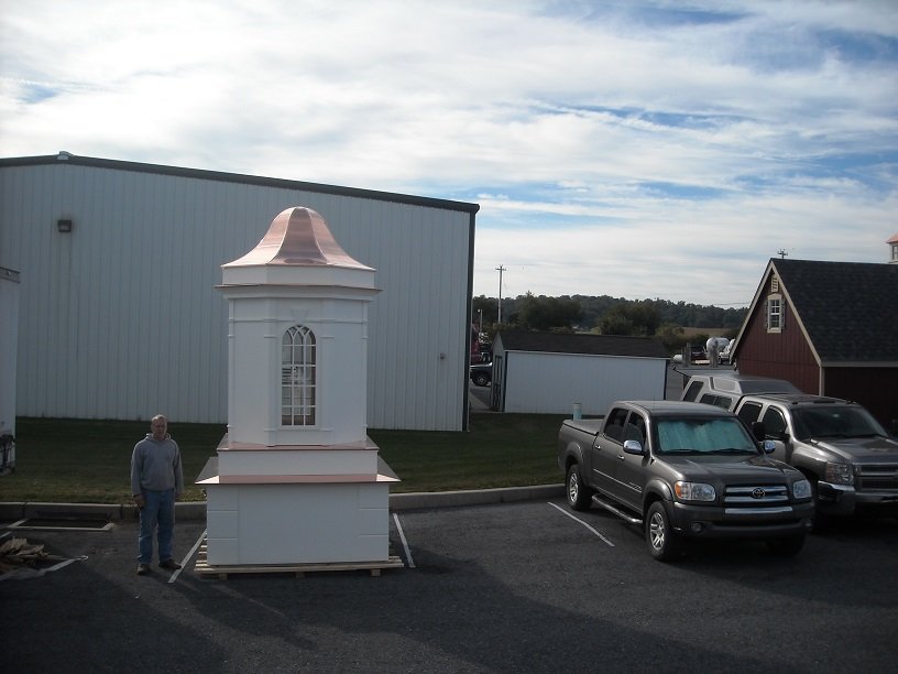 Large custom cupola with copper roof installed outside a building
