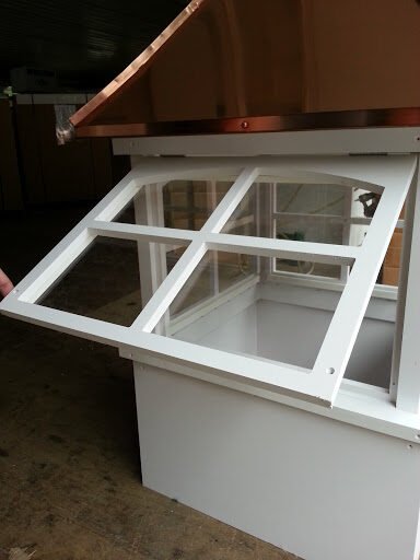 Hinged cupola window opened outward showing ventilation and interior access
